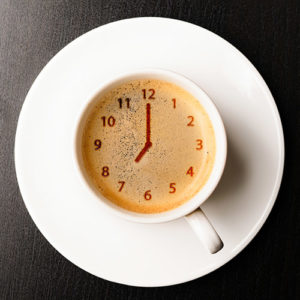 coffee cup with clock formed in foam