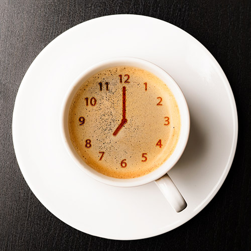 coffee cup with clock formed in foam